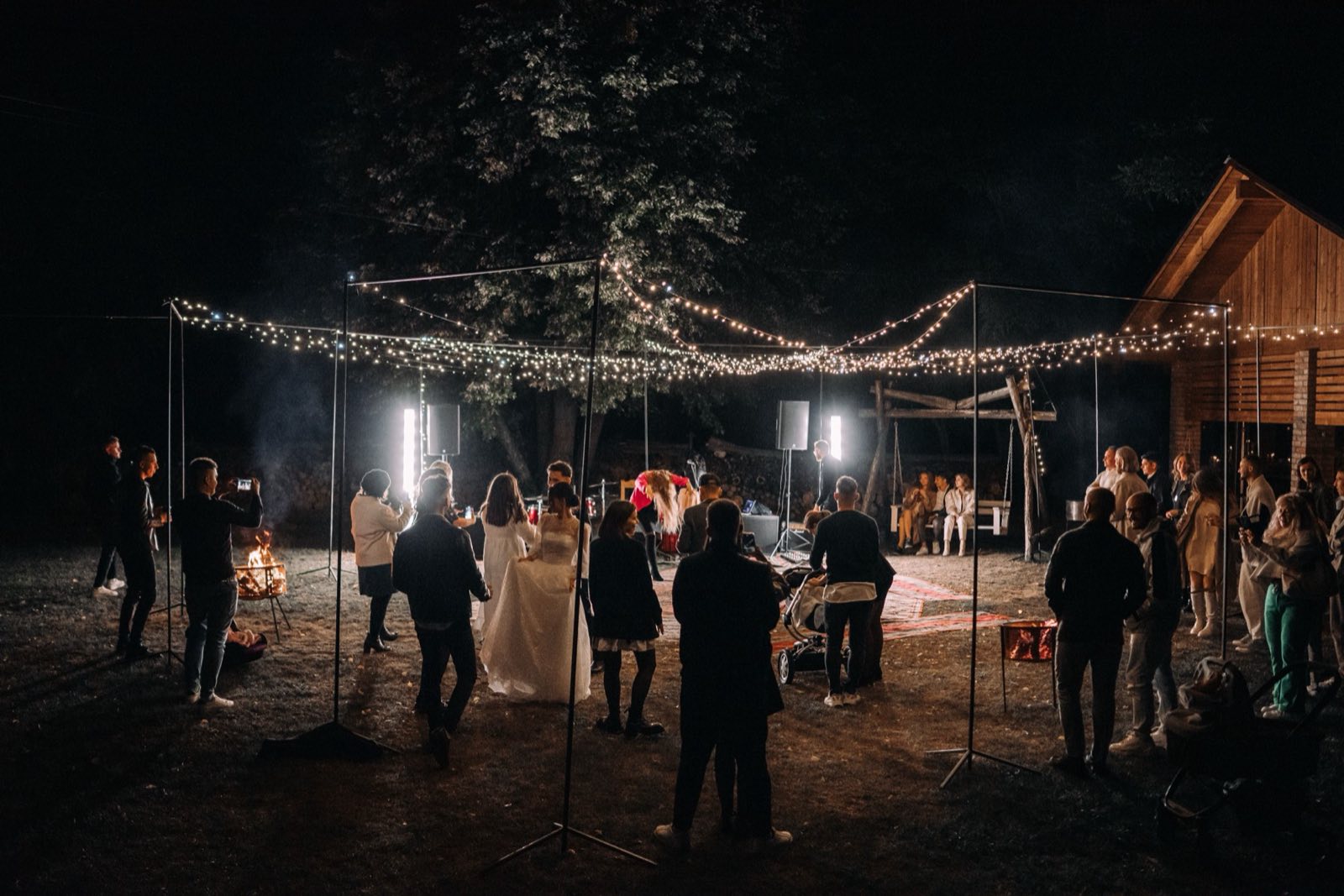 Atmospheric outdoor reception under string lights used as concept imagery